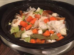 Chicken bone broth is in the slow cooker. - Laura